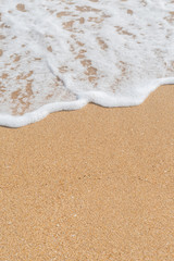 Wave of the sea on the sandy beach