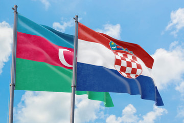 Croatia and Azerbaijan flags waving in the wind against white cloudy blue sky together. Diplomacy concept, international relations.