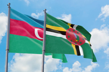Dominica and Azerbaijan flags waving in the wind against white cloudy blue sky together. Diplomacy concept, international relations.