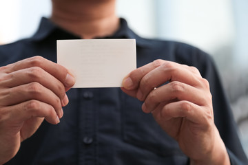 Fototapeta premium Confident male business executive with empty white business card