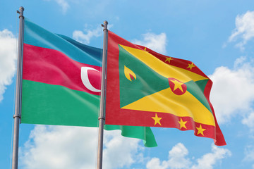 Grenada and Azerbaijan flags waving in the wind against white cloudy blue sky together. Diplomacy concept, international relations.
