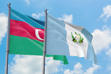 Guatemala and Azerbaijan flags waving in the wind against white cloudy blue sky together. Diplomacy concept, international relations.