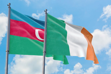 Ireland and Azerbaijan flags waving in the wind against white cloudy blue sky together. Diplomacy concept, international relations.
