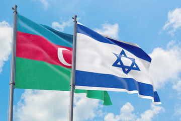 Israel and Azerbaijan flags waving in the wind against white cloudy blue sky together. Diplomacy concept, international relations.