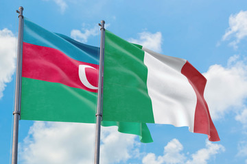 Italy and Azerbaijan flags waving in the wind against white cloudy blue sky together. Diplomacy concept, international relations.