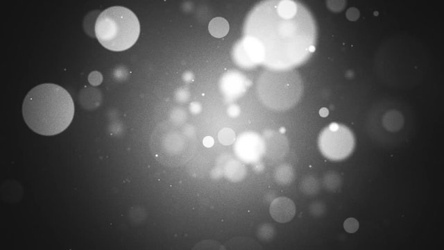 Abstract grayscale bokeh particles background with added grain. Looping, full HD motion animation.