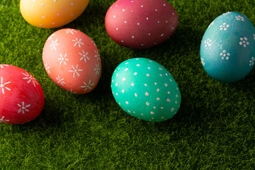 Easter colored eggs on green grass.Flat lay