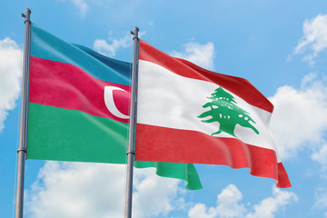 Lebanon and Azerbaijan flags waving in the wind against white cloudy blue sky together. Diplomacy concept, international relations.