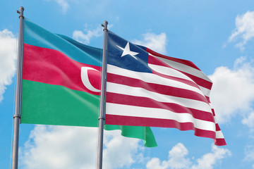Liberia and Azerbaijan flags waving in the wind against white cloudy blue sky together. Diplomacy concept, international relations.