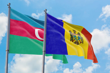 Moldova and Azerbaijan flags waving in the wind against white cloudy blue sky together. Diplomacy concept, international relations.