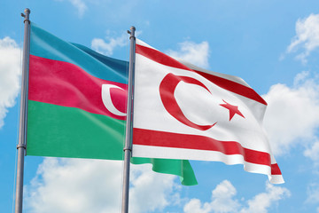 Northern Cyprus and Azerbaijan flags waving in the wind against white cloudy blue sky together. Diplomacy concept, international relations.