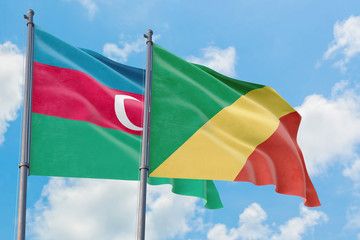 Republic Of The Congo and Azerbaijan flags waving in the wind against white cloudy blue sky together. Diplomacy concept, international relations.