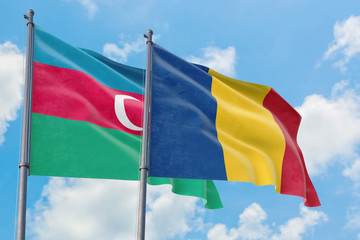 Romania and Azerbaijan flags waving in the wind against white cloudy blue sky together. Diplomacy concept, international relations.