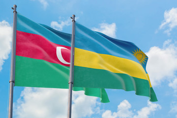 Rwanda and Azerbaijan flags waving in the wind against white cloudy blue sky together. Diplomacy concept, international relations.