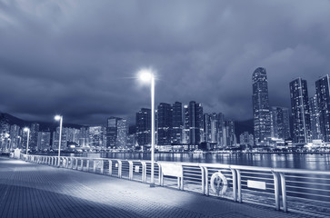 Seaside Promenade and skyline of Harbor in Hong Kong city at dusk