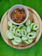 Green mango with sweet fish sauce on green leaf, Thai popular food, Selective focus