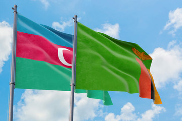 Zambia and Azerbaijan flags waving in the wind against white cloudy blue sky together. Diplomacy concept, international relations.