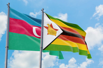 Zimbabwe and Azerbaijan flags waving in the wind against white cloudy blue sky together. Diplomacy concept, international relations.