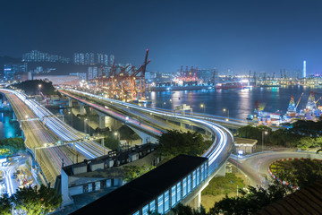 Naklejka premium Cargo port and highway in Hong Kong city at night