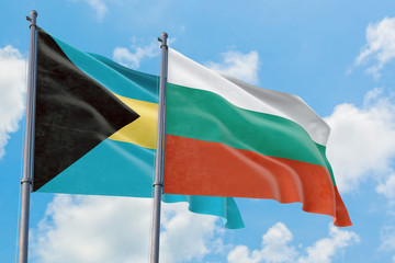 Bulgaria and Bahamas flags waving in the wind against white cloudy blue sky together. Diplomacy concept, international relations.