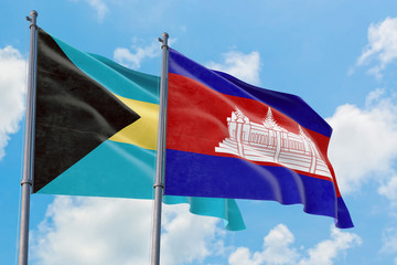 Cambodia and Bahamas flags waving in the wind against white cloudy blue sky together. Diplomacy concept, international relations.