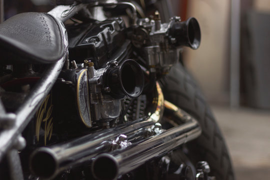 Modified chopper-style motorcycle engine with double carburetor and double muffler