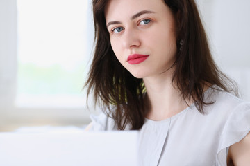 Beautiful smiling businesswoman portrait at workplace look in camera. White collar worker at...
