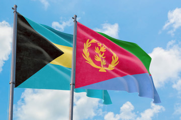 Eritrea and Bahamas flags waving in the wind against white cloudy blue sky together. Diplomacy concept, international relations.