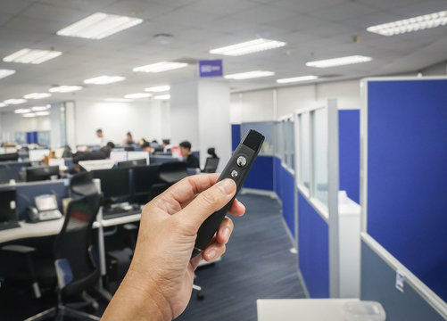 close up people hand hold wireless presentation pointer in office for meeting and conference