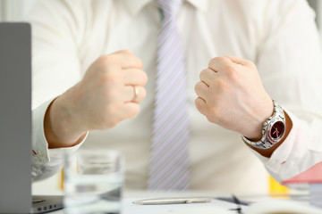 Male clenched fist in suit at office closeup. Aggressive career strategy angry negotiation strong...