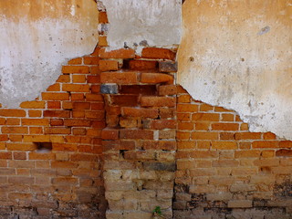 old red brick wall with hole
