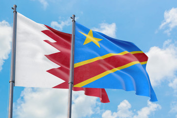 Congo and Bahrain flags waving in the wind against white cloudy blue sky together. Diplomacy concept, international relations.