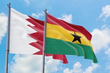 Ghana and Bahrain flags waving in the wind against white cloudy blue sky together. Diplomacy concept, international relations.