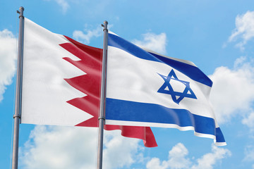 Israel and Bahrain flags waving in the wind against white cloudy blue sky together. Diplomacy concept, international relations.