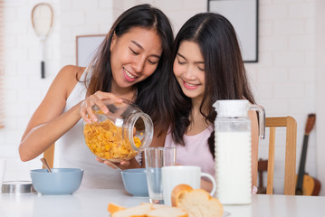 Happy asian lesbian woman couple have breakfast at house in morning with love and tender.LGBTQ lifestyle concept