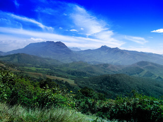 Western Ghats mountains region with blue sky and Munnar tea plantation in Southern part of India, Kerala.