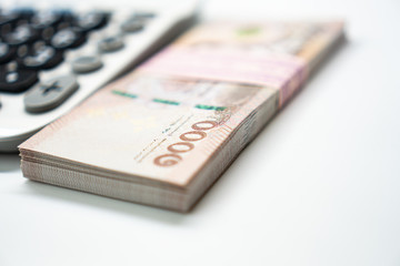 Close up calculator and 1000 Thai Bath currency money banknote. Background concept for thailand financial and  economy.