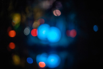 Defocused orbs of blue bokeh lights at night
