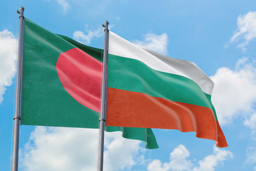 Bulgaria and Bangladesh flags waving in the wind against white cloudy blue sky together. Diplomacy concept, international relations.