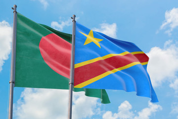 Congo and Bangladesh flags waving in the wind against white cloudy blue sky together. Diplomacy concept, international relations.