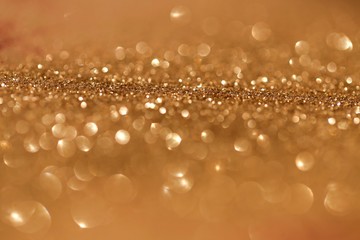 Golden shine background. Gold glitter with golden shiny bokeh. Glitter macro shimmer  texture....
