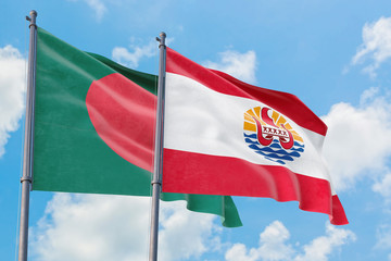 French Polynesia and Bangladesh flags waving in the wind against white cloudy blue sky together. Diplomacy concept, international relations.