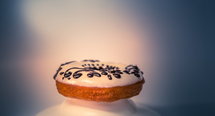 Assorted donuts with white chocolate frosted and dark chocolate design