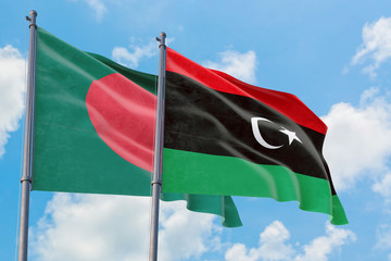Libya and Bangladesh flags waving in the wind against white cloudy blue sky together. Diplomacy...