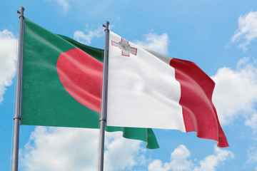 Malta and Bangladesh flags waving in the wind against white cloudy blue sky together. Diplomacy concept, international relations.