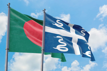 Martinique and Bangladesh flags waving in the wind against white cloudy blue sky together. Diplomacy concept, international relations.