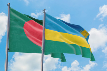Rwanda and Bangladesh flags waving in the wind against white cloudy blue sky together. Diplomacy concept, international relations.