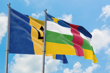 Central African Republic and Barbados flags waving in the wind against white cloudy blue sky together. Diplomacy concept, international relations.