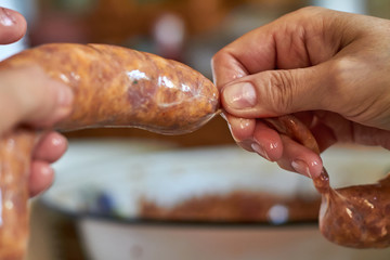 A woman manually makes homemade sausage using natural gut. Traditional cuisine. Selective focus