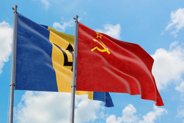 Soviet Union and Barbados flags waving in the wind against white cloudy blue sky together. Diplomacy concept, international relations.